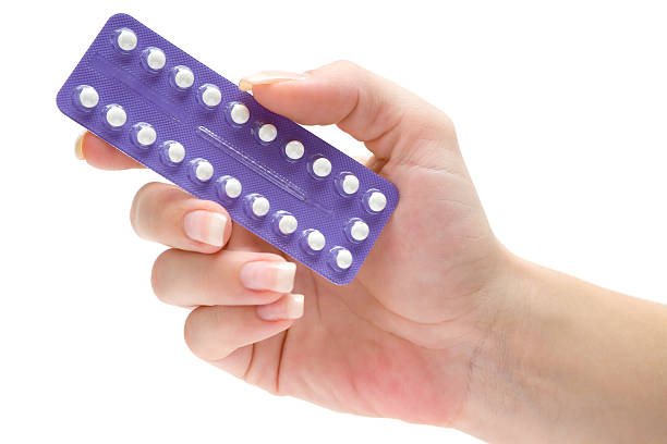 Mão de uma mulher segurando uma cartela de anticoncepcional | Prevenção da endometriose